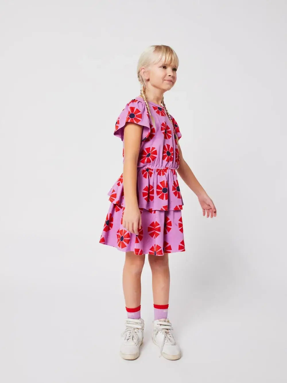 Niña con vestido morado con manga corta, volante en la cintura y estampado de caleidoscopios, Bobo Choses.