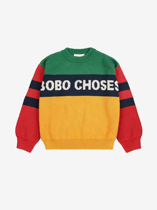 Jersey infantil Bobo Choses de manga larga en bloques verde, amarillo y rojo, con franjas azul marino en las mangas y logo en el pecho