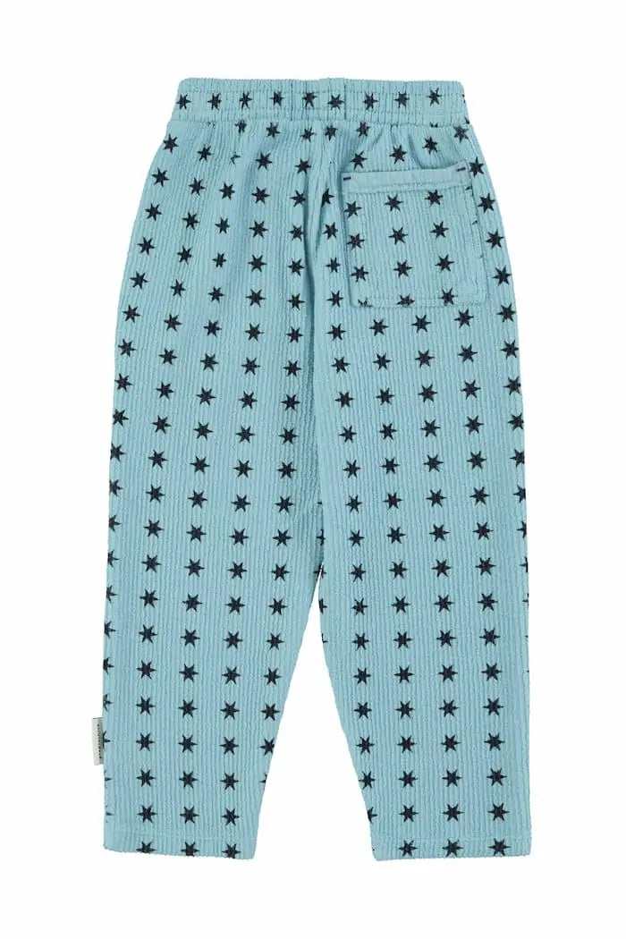 Pantalones jogging de felpa de color azul con estampado de estrellas negras y bolsillo en la parte trasera, Piupiuchick.