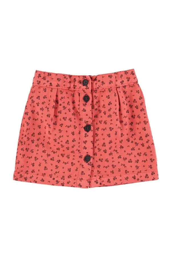 Falda corta de color rosa con estampado de flores negros para niñas de Piupiucick.