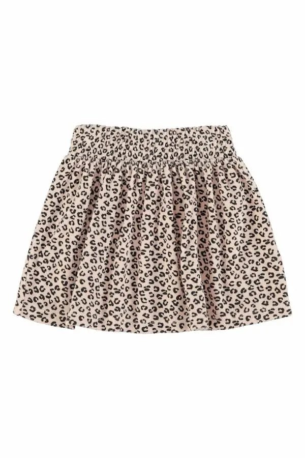 Falda corta  rosa claro de rizo con estampado negro de animal print para niñas de Piupiuchick.