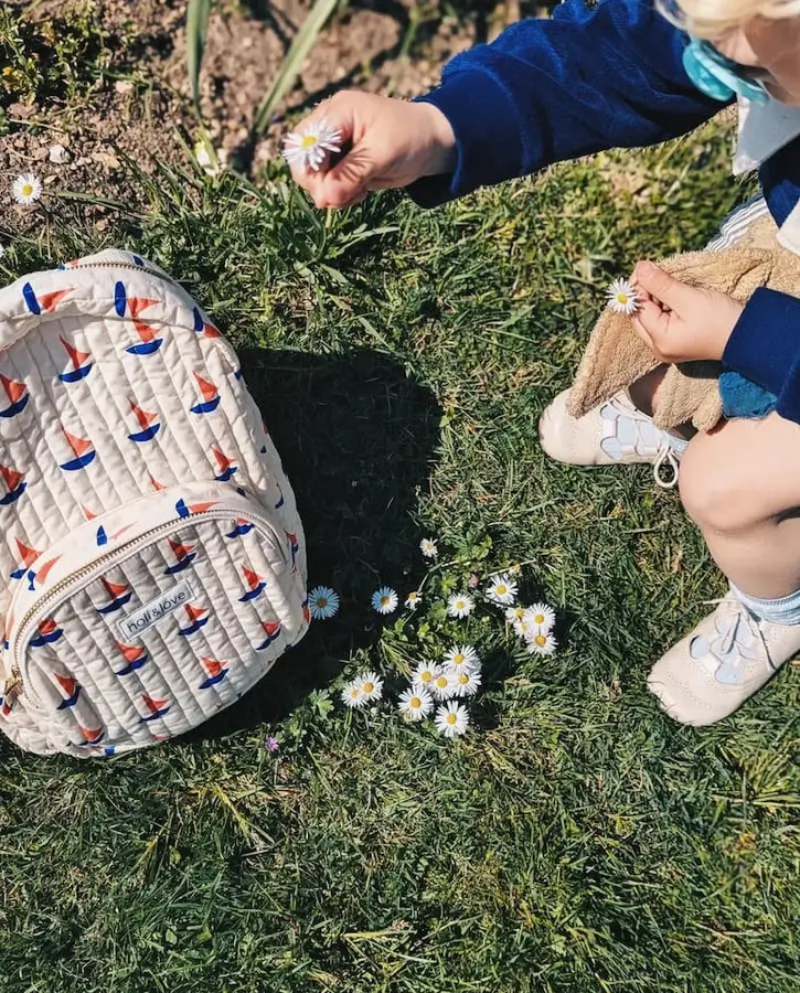 Mochila con estampado de barcos en  el suelo.