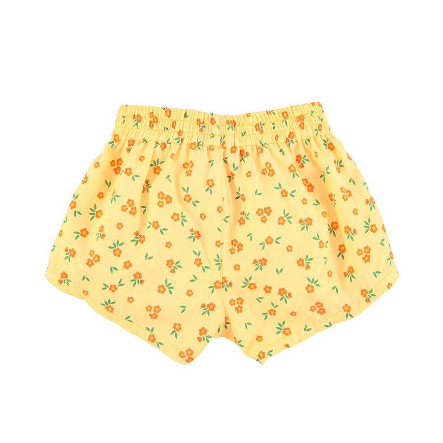 Vista atras de shorts amarillos con estampado de flores